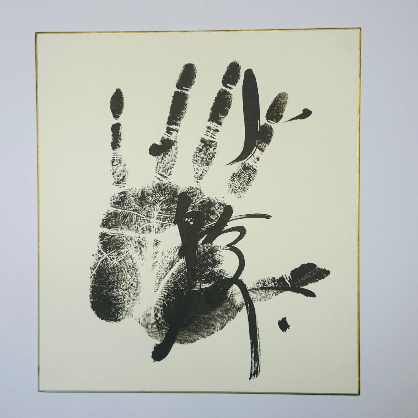 Calligraphy with handprint on cream background