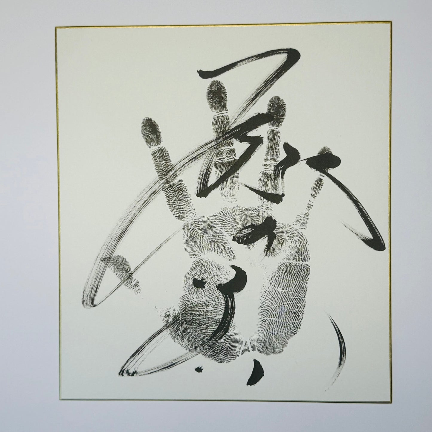 Calligraphy with handprint on cream background