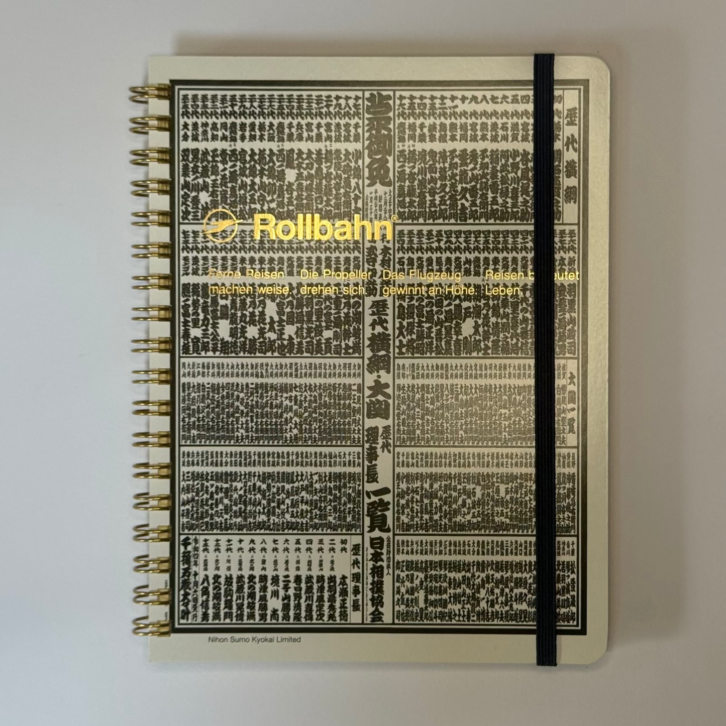 Notebook with a banzuke design on the cover against a plain background