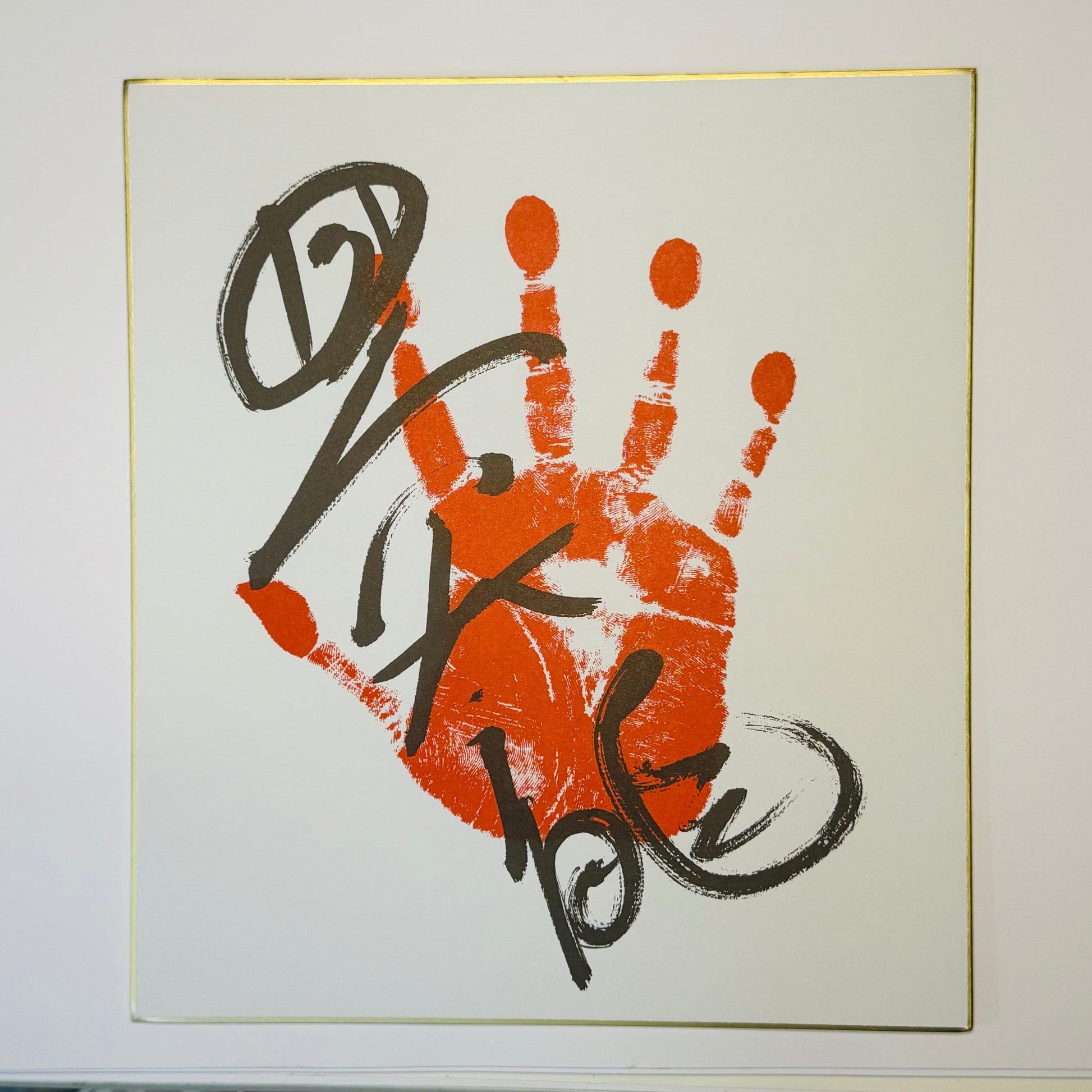 Calligraphy with handprint on cream background