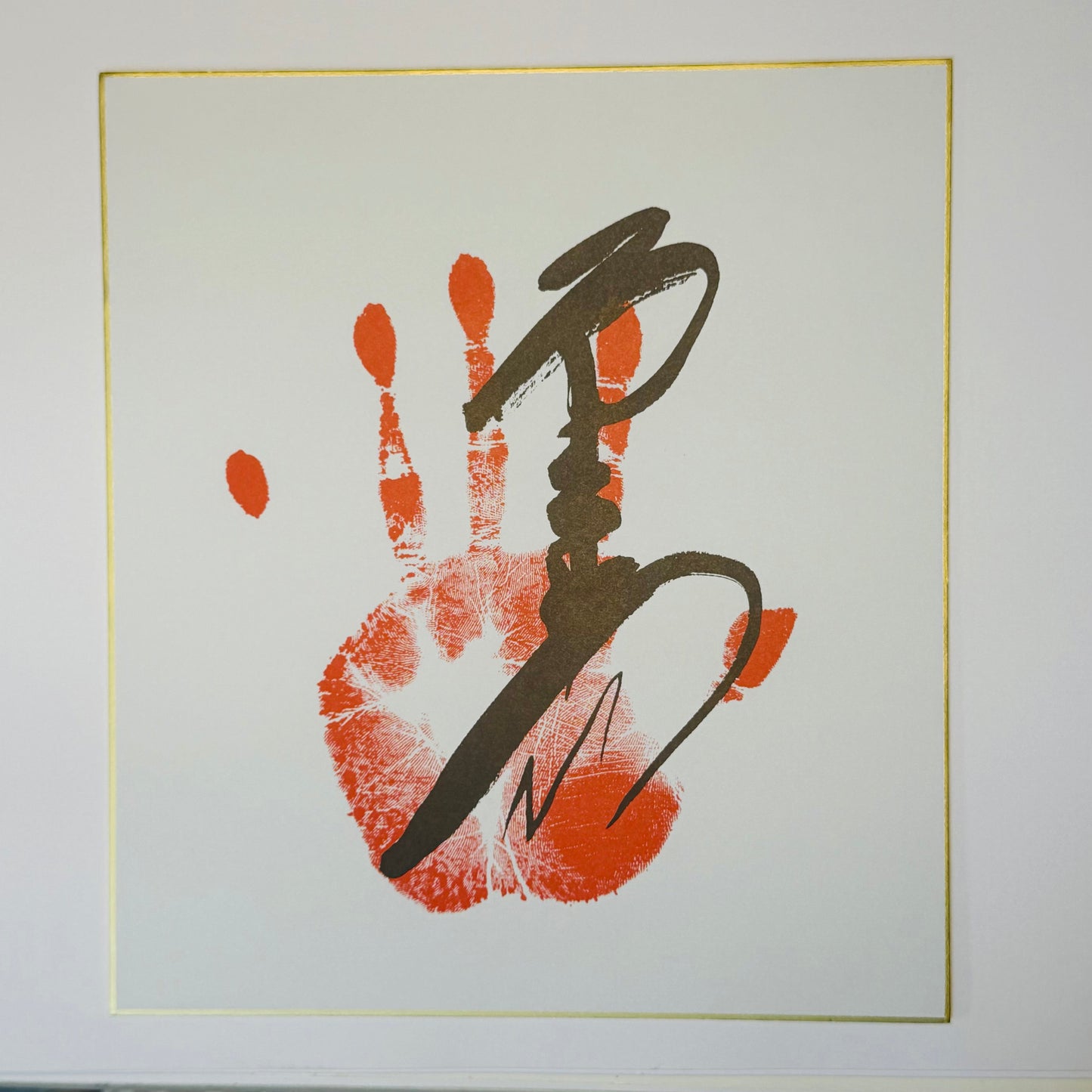 Calligraphy with handprint on cream background