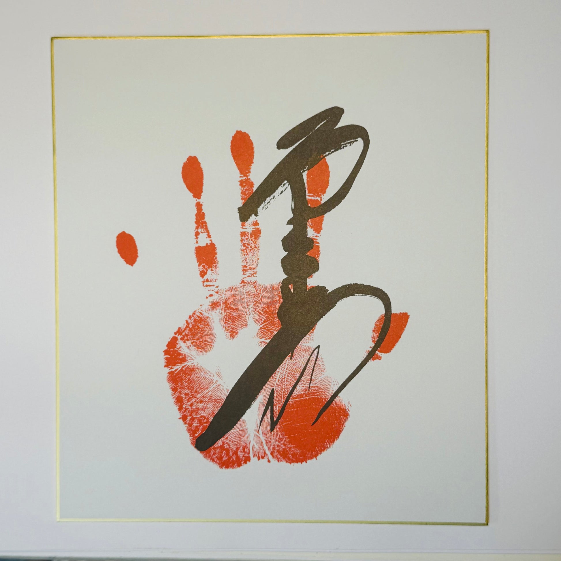 Calligraphy with handprint on cream background